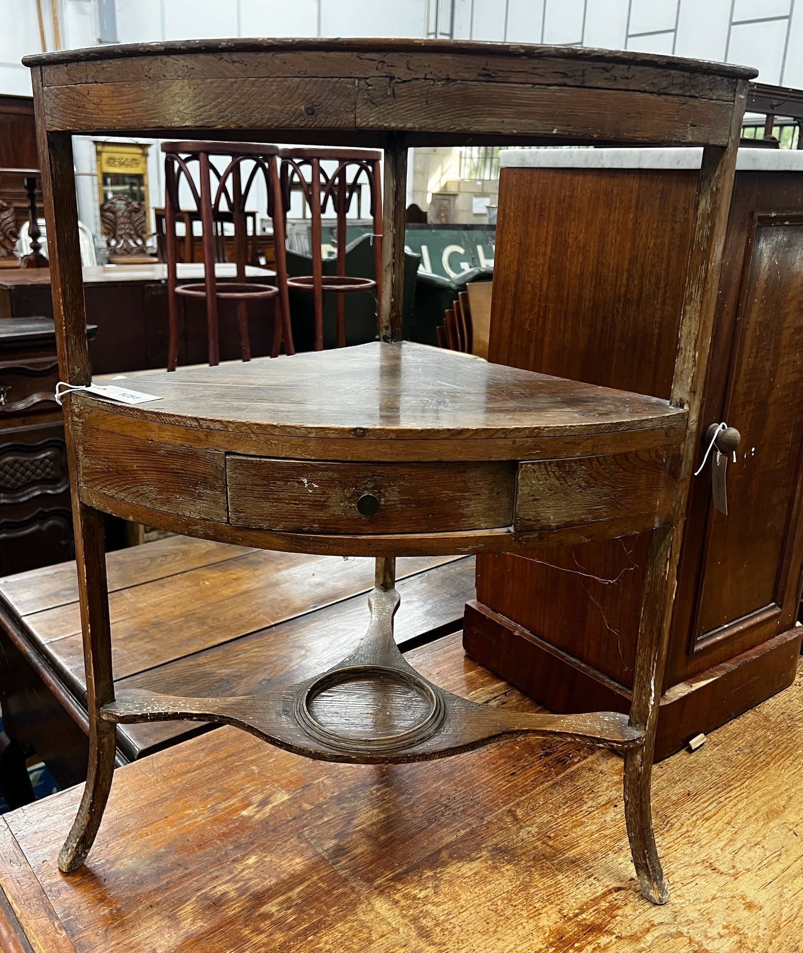 A George III pine bowfront three tier corner washstand, width 60cm depth 40cm height 80cm